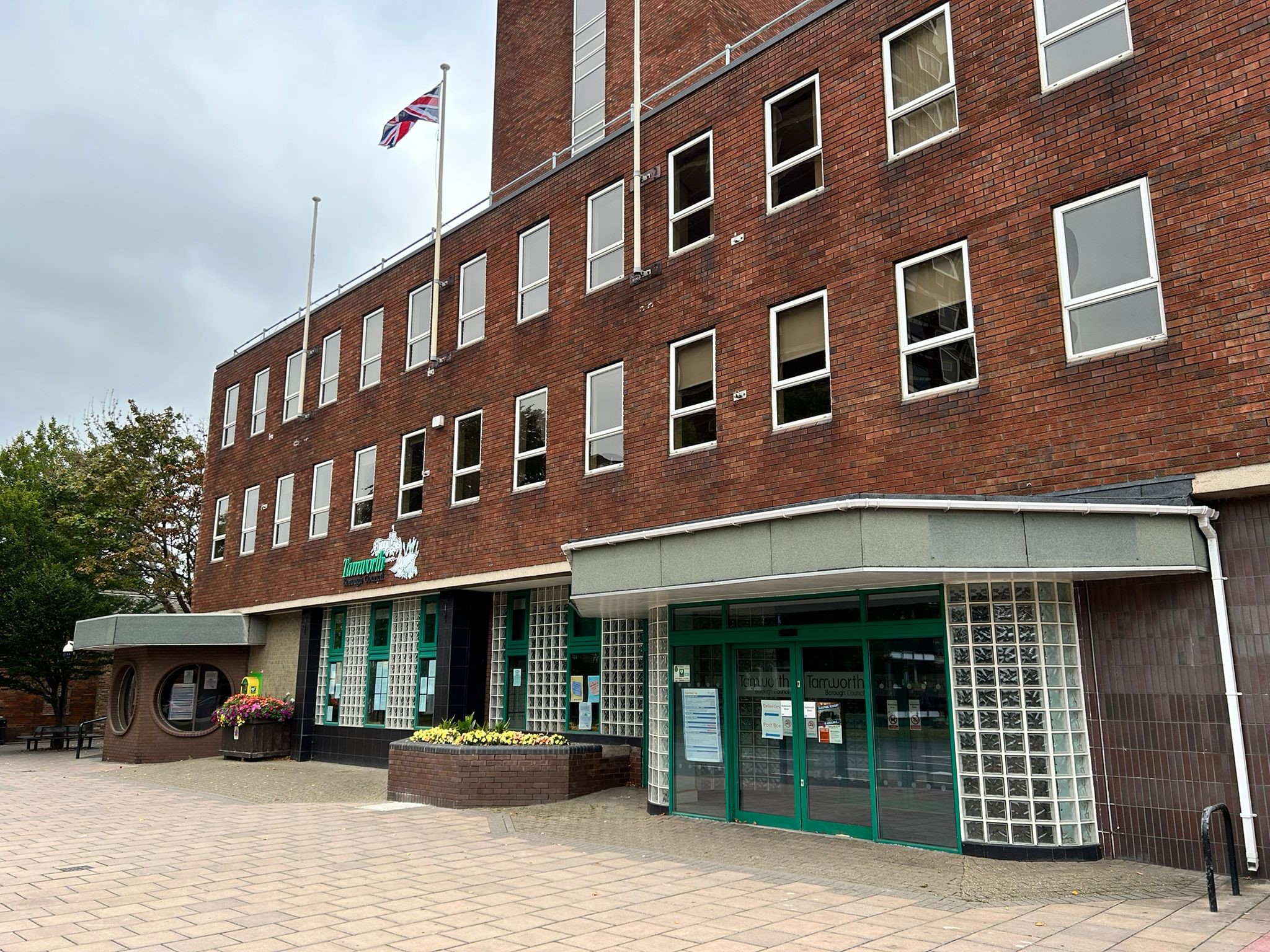 The outside of Marmion House. The council brick building with lots of windows and green doors.