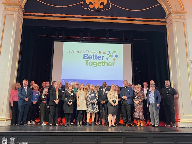 group photo on Assembly Rooms stage of partners from local services