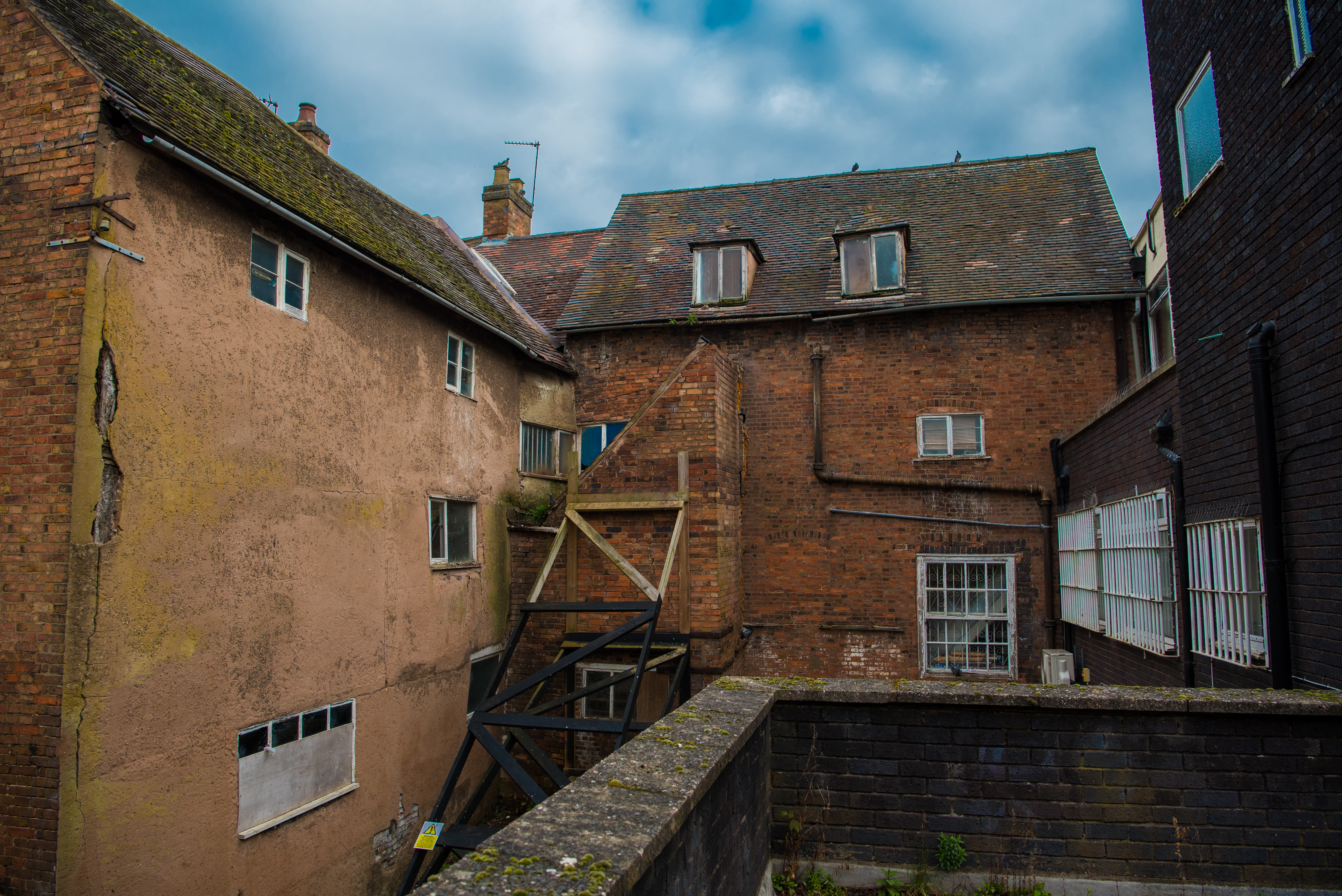 old building from the back with an outside staircase and old windows