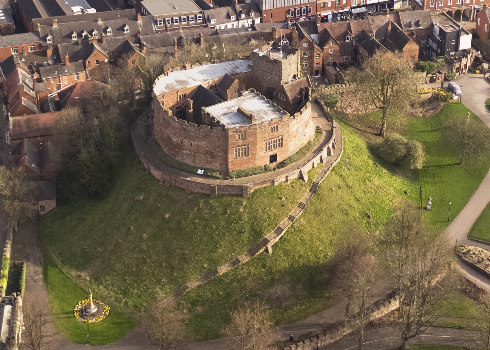 aerial photo of Tamworth Castle and motte with surrounding green grass and Georgian buildings