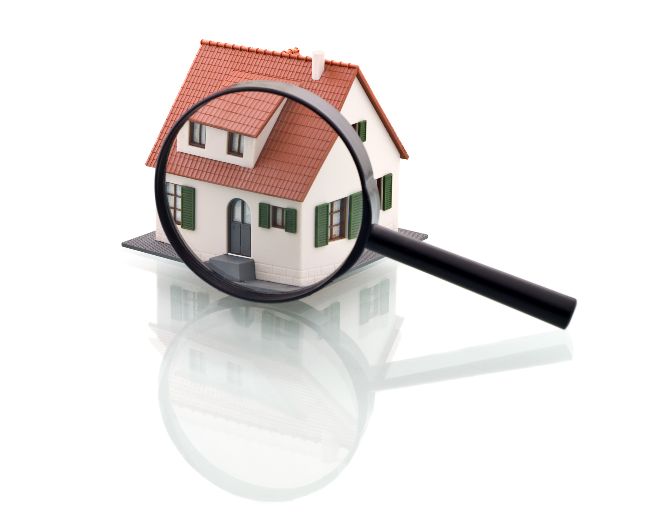A magnifying glass over a graphic image of a house