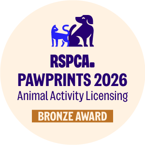 round logo with a blue dog and writing 