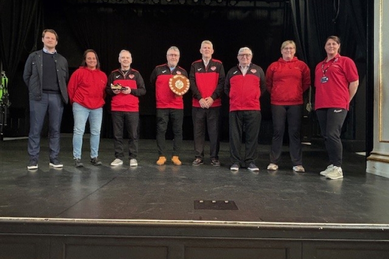 group photo on the Assembly rooms stage with a football shield