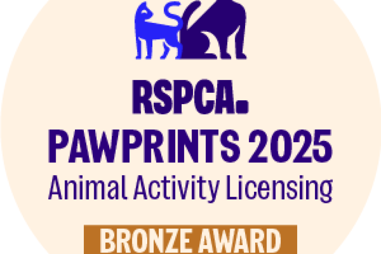 Bronze paw print award logo