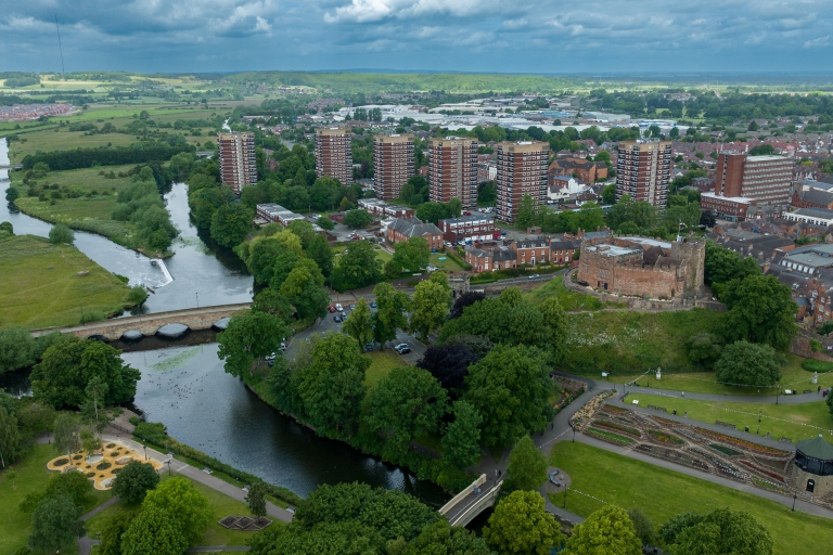 houses and flats drone view with a river and castle