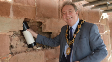 Mayor John Harper with the time capsule in the hole before it gets sealed