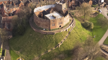 aerial photo of Tamworth Castle and motte with surrounding green grass and Georgian buildings