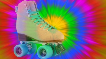 picture of a pair of white roller skates and a bright coloured background