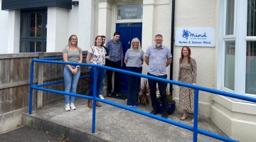 photo showing staff of Burton on mind outside their office building 