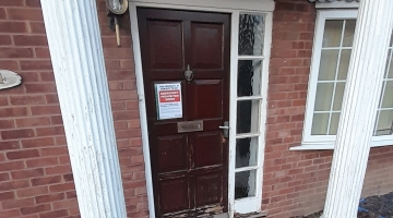 Image of front door with a notice on