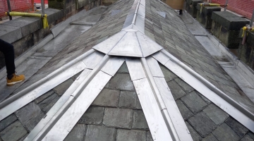 photo of a roof with metal and slate tiles