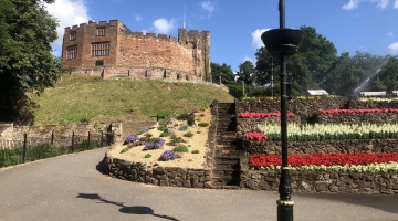 photo of a castle and flowerbeds 